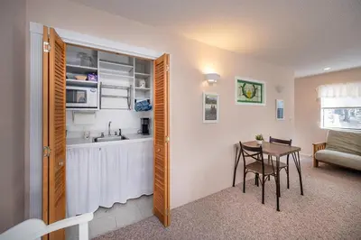 a kitchen and dining room with a table and a sink at Arnold A Frame Cabin with Hot Tub and Guest Suite in Arnold