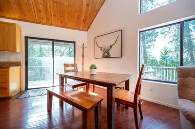 a dining room with a table and chairs in a room at Arnold A Frame Cabin with Hot Tub and Guest Suite in Arnold