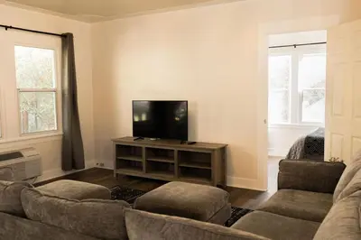 a living room with a couch and a flat screen tv at Yosemite Cottage Retreat- Half Block to Downtown in Mariposa