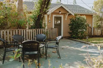 a group of chairs sitting in front of a house at Yosemite Cottage Retreat- Half Block to Downtown in Mariposa