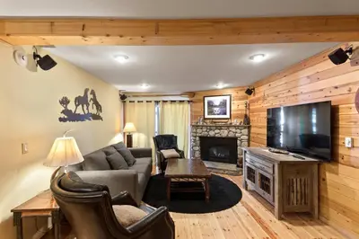 a living room with a couch and a tv and a fireplace at Chamonix #15 - Cozy Mtn Retreat with Fireplace in Mammoth Lakes