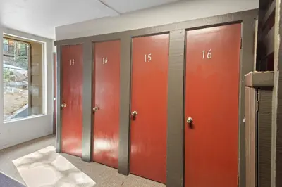 a row of lockers in a room with red doors at Chamonix #15 - Cozy Mtn Retreat with Fireplace in Mammoth Lakes
