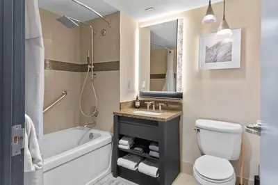 a bathroom with a tub and a toilet and a sink at Hillside #508 - Cozy Studio w King Bed Fireplace & Kitchenette in Mammoth Lakes