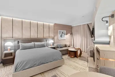 a bedroom with a bed and a living room at Hillside #508 - Cozy Studio w King Bed Fireplace & Kitchenette in Mammoth Lakes