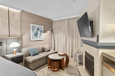 a living room with a couch and a tv at Hillside #508 - Cozy Studio w King Bed Fireplace & Kitchenette in Mammoth Lakes