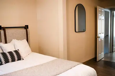 a bedroom with a bed and a mirror on the wall at Family Getaway Near Yosemite - Downtown Mariposa in Mariposa