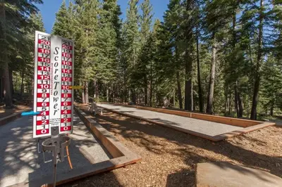 a sign in the middle of a park with trees at Martis Landing home in Truckee