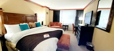 a hotel room with a large bed and a television at Dav's Slopeside King Studio -- Resort & Spa at Everline in Olympic Valley