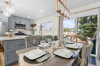a dining room with a table and a kitchen at Luxury Hyatt Oasis 3 Bedrms 1 Bath SFH for Fun Ski home in South Lake Tahoe