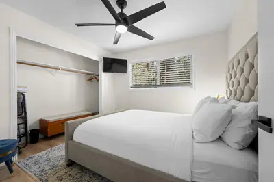 a bedroom with a bed with a ceiling fan at Luxury Hyatt Oasis 3 Bedrms 1 Bath SFH for Fun Ski home in South Lake Tahoe