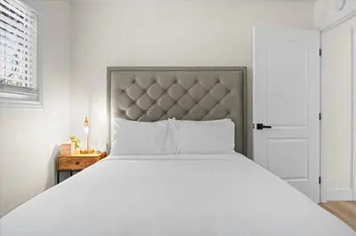 a bedroom with a large white bed and a door at Luxury Hyatt Oasis 3 Bedrms 1 Bath SFH for Fun Ski home in South Lake Tahoe