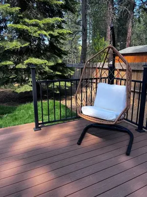 a wicker chair sitting on a wooden deck at Luxury Hyatt Oasis 3 Bedrms 1 Bath SFH for Fun Ski home in South Lake Tahoe