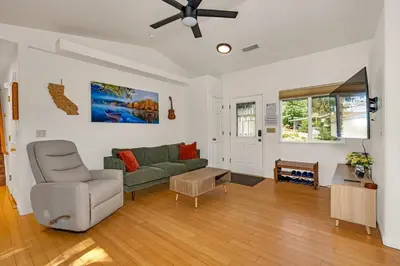 a living room with a green couch and a ceiling fan at Yosemite Terrace View Retreat in Mariposa