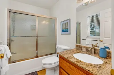 a bathroom with a toilet and a sink and a shower at Yosemite Terrace View Retreat in Mariposa