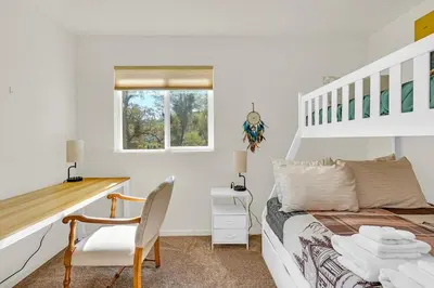 a white bedroom with a bed and a desk at Yosemite Terrace View Retreat in Mariposa