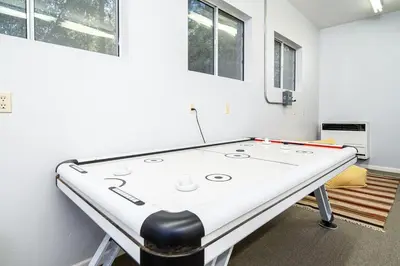 a ping pong table in a living room with at Serenity Pines 1hr to Yosemite w BBQ and Game Room in Mariposa