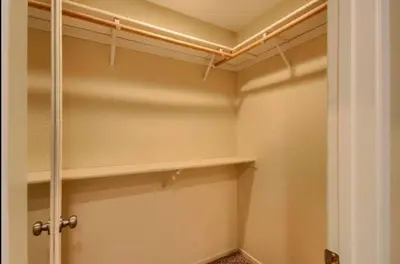 a walk in closet with shelves and a door at Hillside Bungalow - Walking distance to downtown in Mariposa