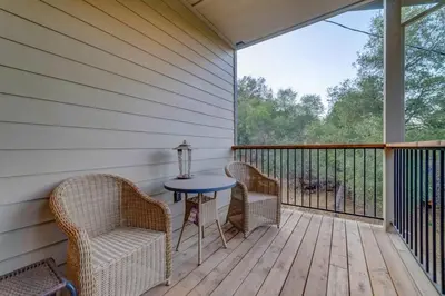 a porch with chairs and a table on a deck at Butterfly View Retreat - 45 Min to Yosemite in Mariposa