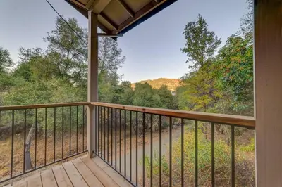 a screened porch with a view of the mountains at Butterfly View Retreat - 45 Min to Yosemite in Mariposa