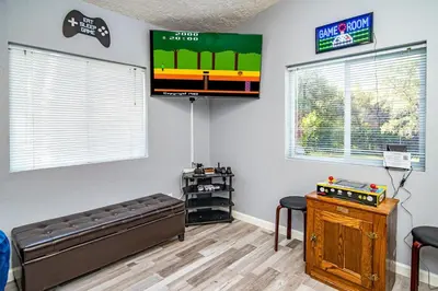 a living room with a flat screen tv on the wall at The Nest-2 K Beds-Game Room-Deck-5 min to Mariposa in Mariposa