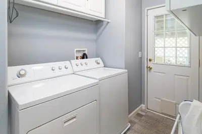 a white laundry room with a washer and dryer at The Nest-2 K Beds-Game Room-Deck-5 min to Mariposa in Mariposa