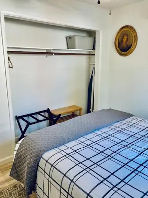 a bedroom with a blue and white bed in a room at Ely Farm House - Near Yosemite National Park in Oakhurst