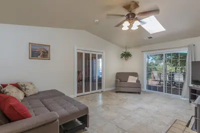 a living room with a couch and a ceiling fan at Sullivan House & SPA Near Yosemite, 8 Min to Town in Mariposa