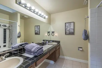 a bathroom with two sinks and a large mirror at Sullivan House & SPA Near Yosemite, 8 Min to Town in Mariposa