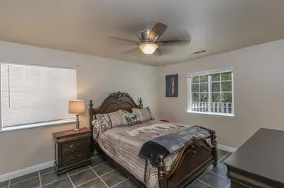 a bedroom with a bed and a ceiling fan at Sullivan House & SPA Near Yosemite, 8 Min to Town in Mariposa