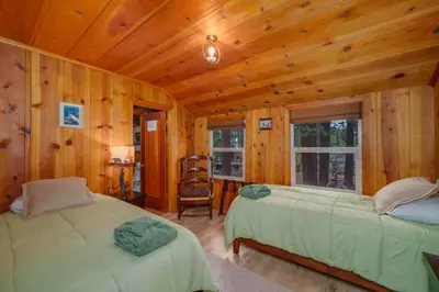 a bedroom with two beds in a wooden cabin at Tahoe Heavenly Hideaway 1060H in South Lake Tahoe
