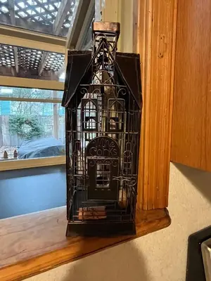 a black bird cage is sitting on a window sill at Tahoe Heavenly Hideaway 1060H in South Lake Tahoe