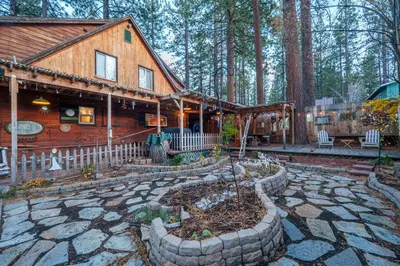 a log cabin with a garden in front of it at Tahoe Heavenly Hideaway 1060H in South Lake Tahoe