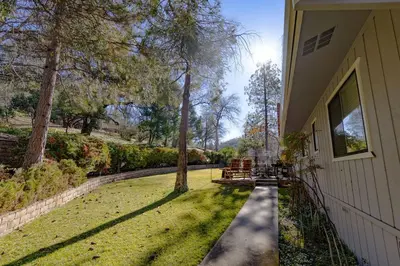 a walkway next to a house with a yard at Kindred Spirits Lodge near Yosemite & Bass Lake! in Oakhurst