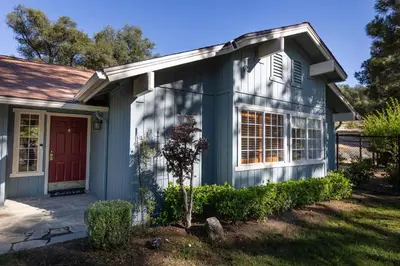 a blue house with a red door at Moonrise Retreat, SPA, Near Yosemite & Bass Lake in Oakhurst