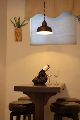 a bottle of wine on a table with two glasses at Cozy Cabin Near Yosemite & Corlieu Falls in Oakhurst