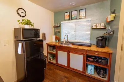 a kitchen with a sink and a refrigerator at Cozy Cabin Near Yosemite & Corlieu Falls in Oakhurst