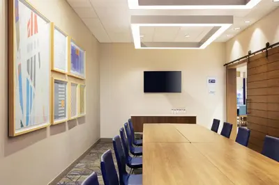 a conference room with a long table and chairs at Holiday Inn Express & Suites Sparks Reno East by IHG in Sparks