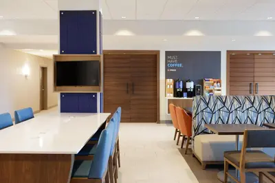a dining room with a large table and chairs at Holiday Inn Express & Suites Sparks Reno East by IHG in Sparks