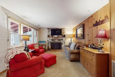 a living room with red furniture and a fireplace at Basecamp on Aspen in South Lake Tahoe