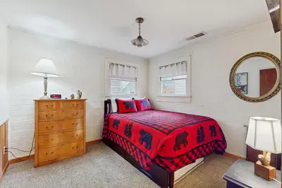 a bedroom with a bed and a dresser and a mirror at Basecamp on Aspen in South Lake Tahoe