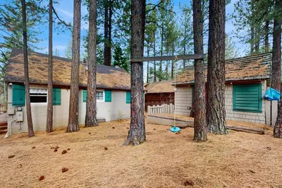 a house with a group of trees in front of it at Basecamp on Aspen in South Lake Tahoe