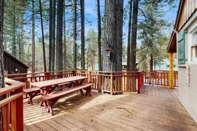 a wooden deck with a picnic table next to a tree at Basecamp on Aspen in South Lake Tahoe