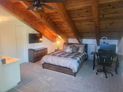 a bedroom with a bed and a desk with a television at Heavenly Stagecoach Ski Retreat in Stateline