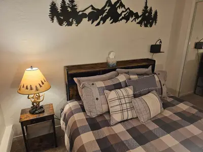 a bedroom with a bed with a lamp on a table at Heavenly Stagecoach Ski Retreat in Stateline