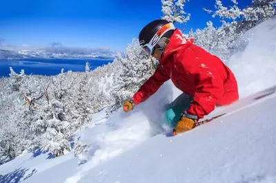 a man riding a snowboard down a snow covered slope at Heavenly Stagecoach Ski Retreat in Stateline