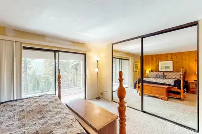 a bedroom with a bed and sliding glass doors at Eagle's Nest in Big Creek