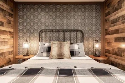 a bedroom with a large bed with two lamps at Acorn Falls, Bass Lake, Ca in Bass Lake