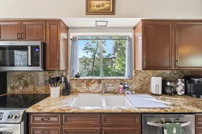 a kitchen with a sink and a window at Boss's Cabin - Boss-level views, zero stress! in Shaver Lake
