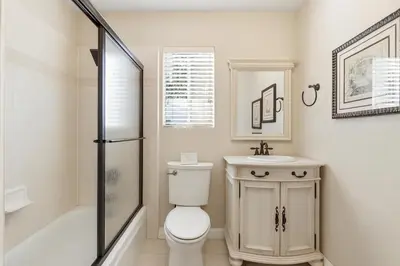 a bathroom with a toilet and a sink and a shower at Boss's Cabin - Boss-level views, zero stress! in Shaver Lake