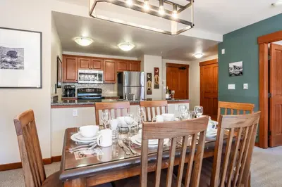 a dining room with a wooden table and chairs at Village 1209 in Mammoth Lakes